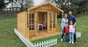 Family posing in front of the new Diggerland Private Site Huts